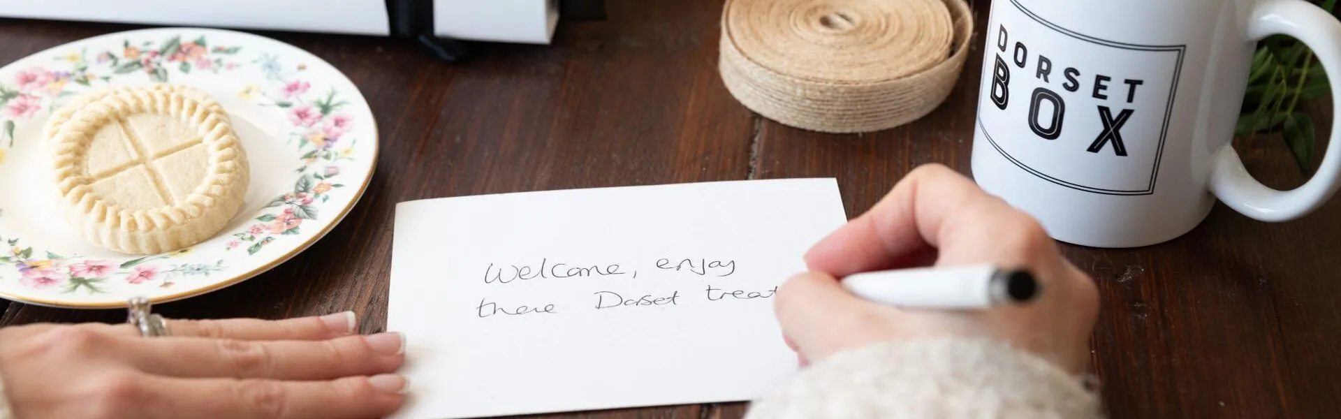 Hand writing a Dorset Box gift card